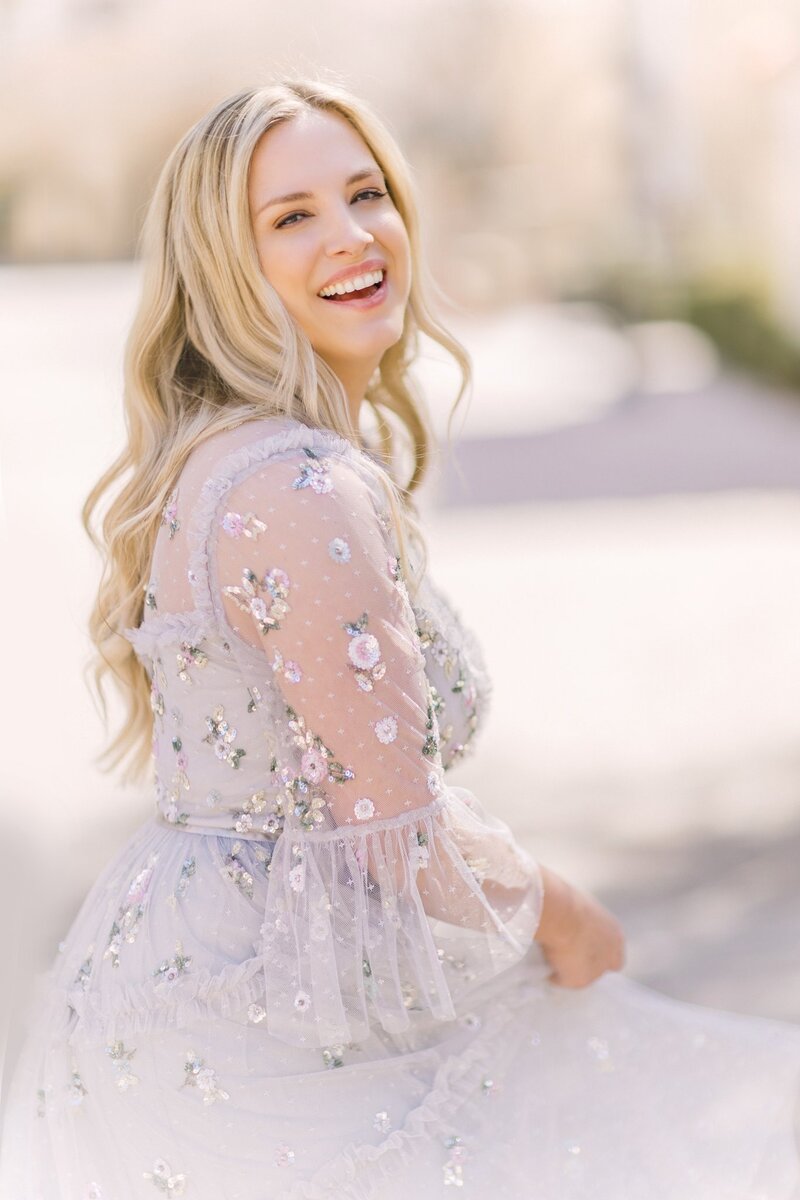 Headshot of Morgan with Morgan Leigh Photography based out of Baton Rouge, LA. Dressed in floral Nothing Fits But dress.