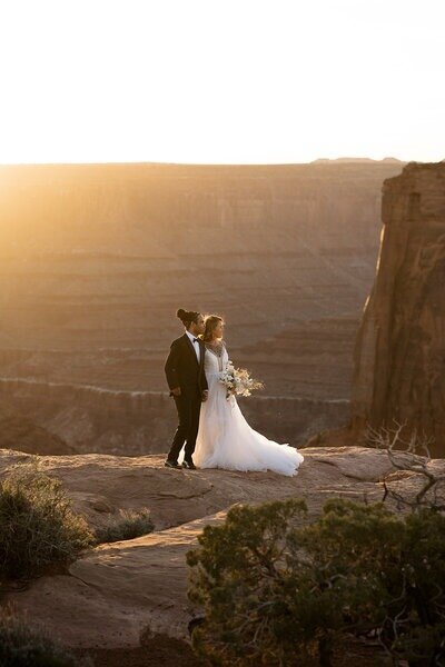 Couple enjoying the sunset from a beautiful overlook in utah.