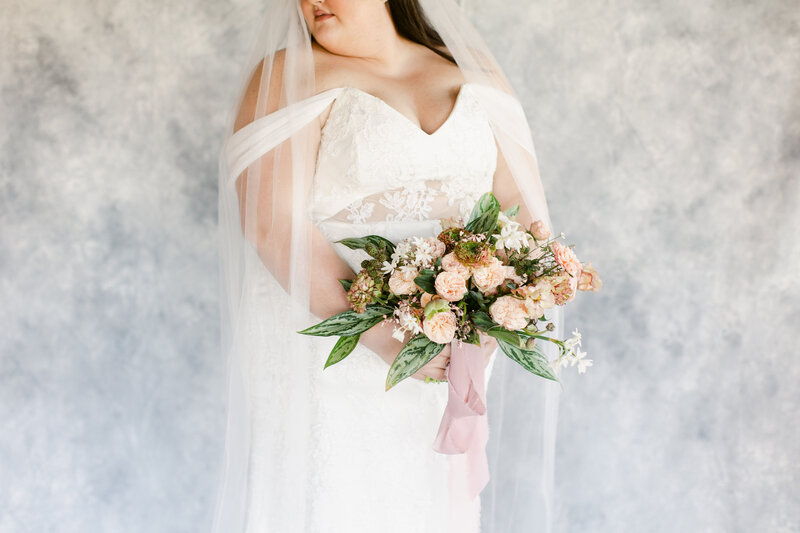 Bride holding an all blush bouquet