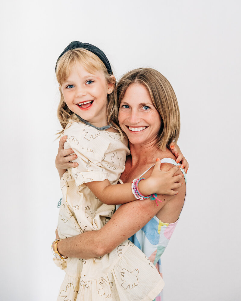 Alison happily holding her daughter for a photo in st. pete
