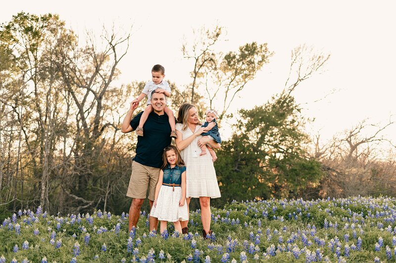 Family of five in Texas bluebonnets by Cypress Family Photographer
