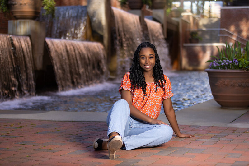 Willow Spring High School Senior portraits sitting in front of waterfalls in Durham, NC.