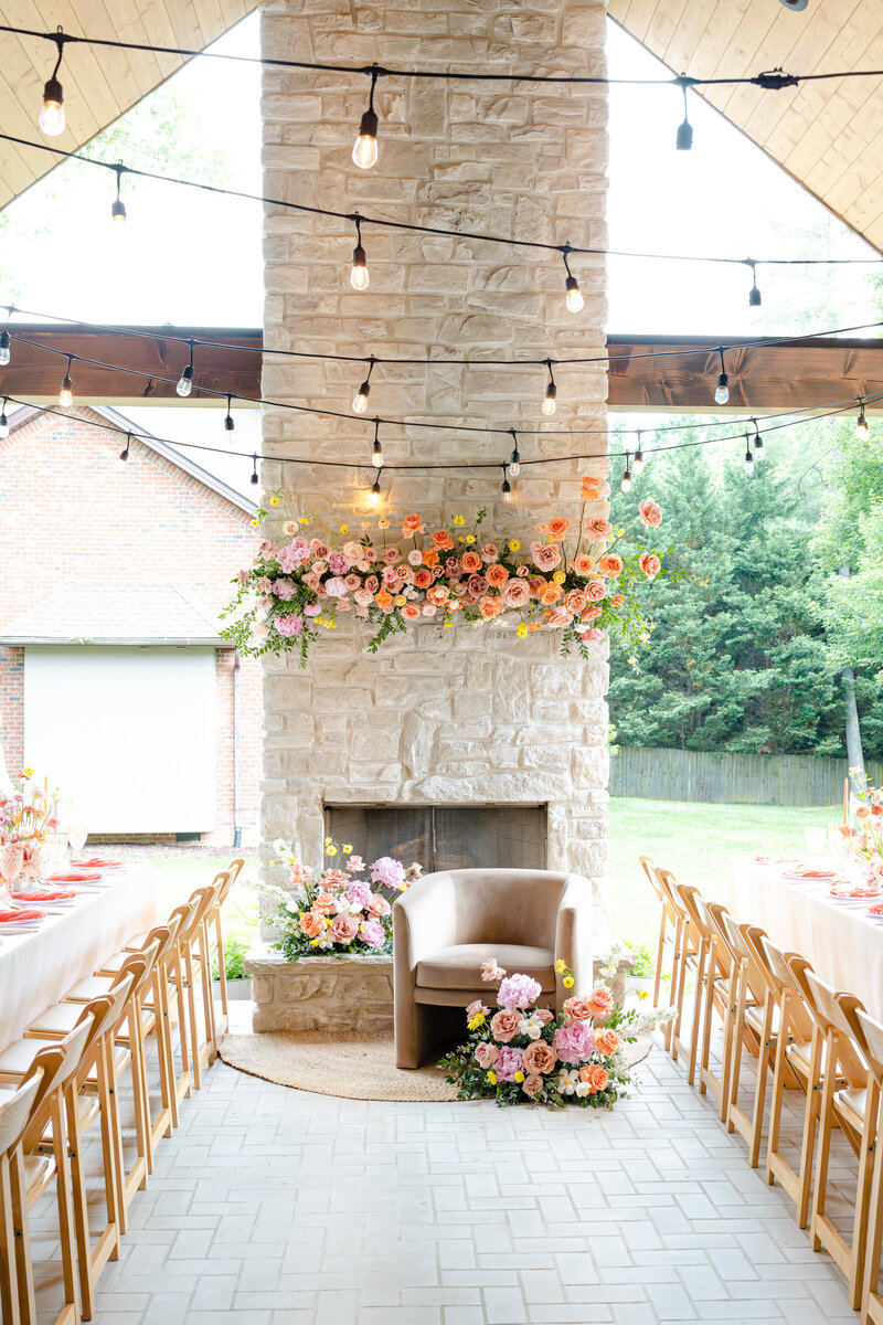 Indoor wedding reception with string lights and colorful floral designs  by Lancaster wedding planner & floral designer