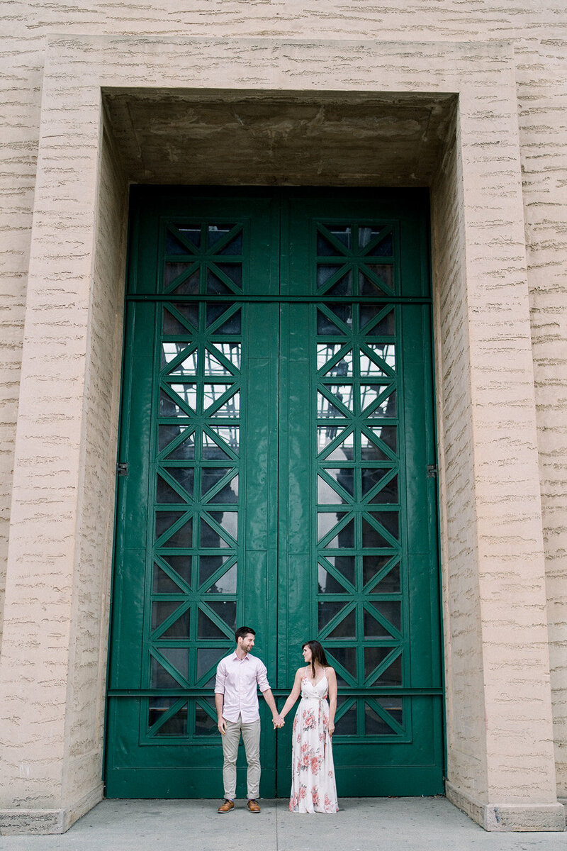 A couple poses in front of the grand entrance of the Legion of Honor in San Francisco, California, captured by Tiffany Longeway Photography.