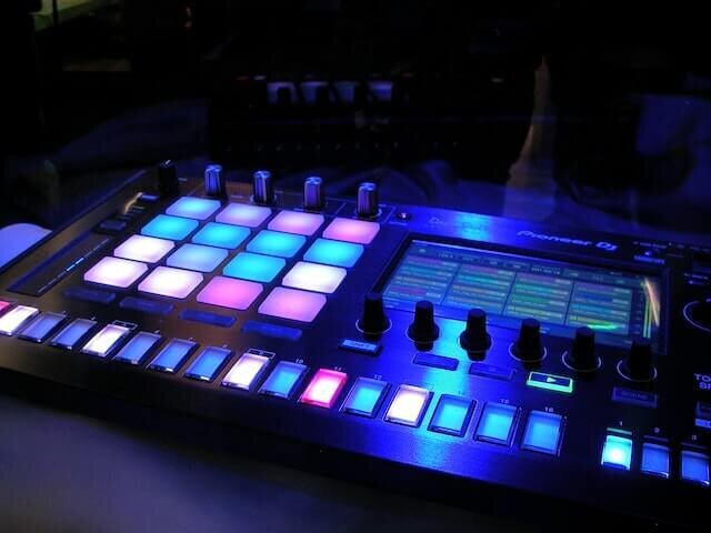 DJ sound board with pink , white and blue  lit up buttons