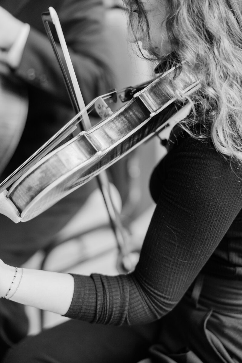 a black and white photo of a woman playing a violin at a wedding in west palm beach