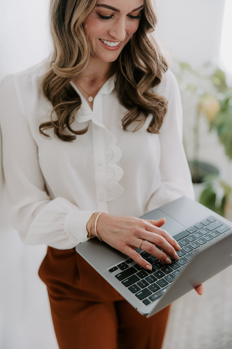 A copywriter for websites holding a laptop