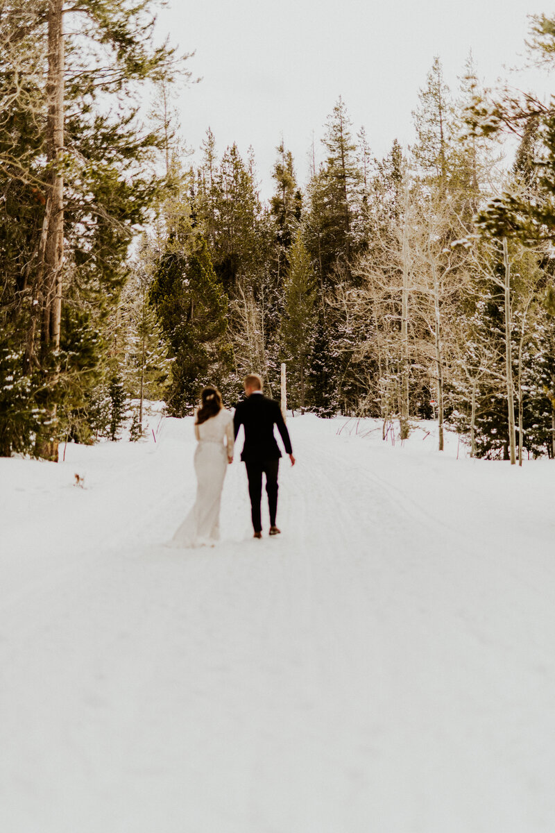 Couple sharing vows during their elopement on a frozen mountain lake in Alaska.