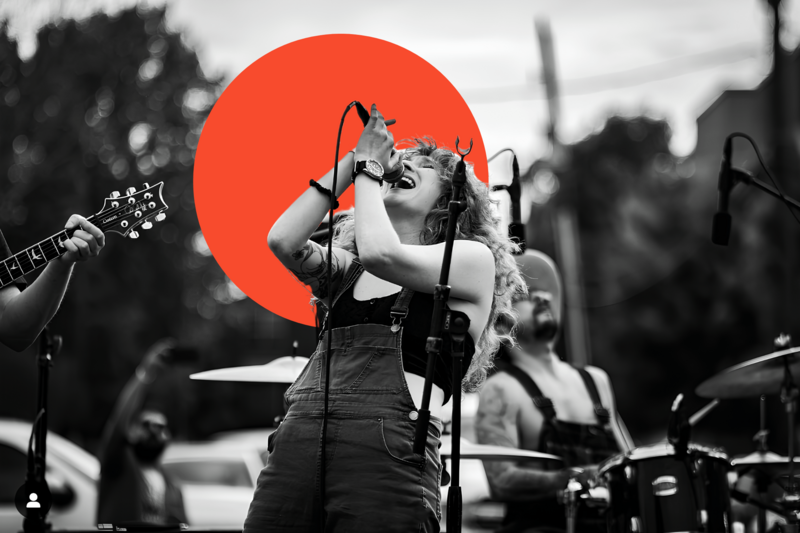 Allison on stage at the Moontower Anniversary festival in Houston, Texas, wailing into a microphone.