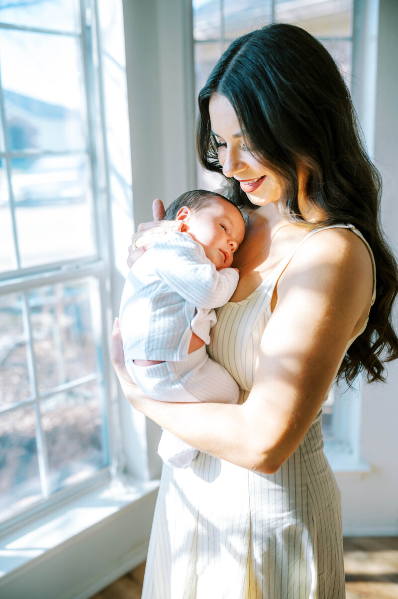 mom and dad cradling newborn