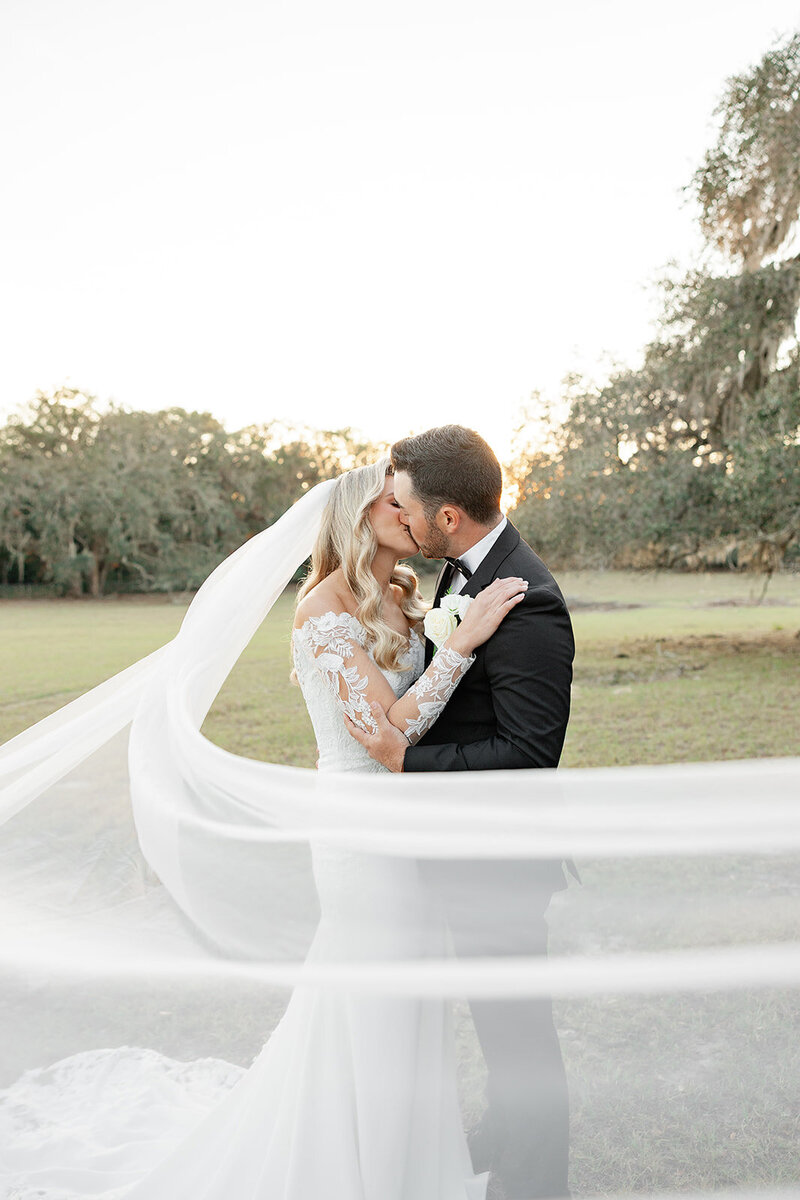 Moss Estates Wedding By Orlando Wedding Photographer bride and groom kissing under veil 