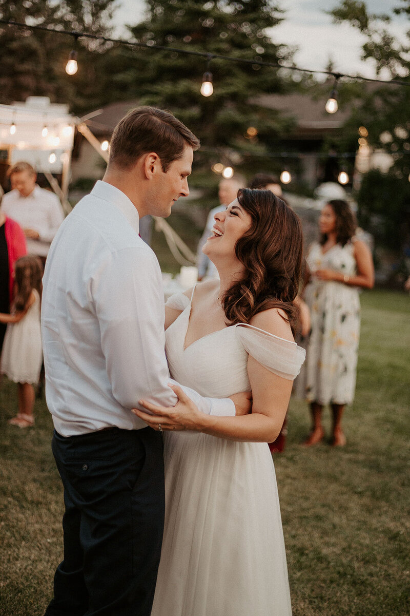 bride and groom embracing during their backyard wedding in Winnipeg