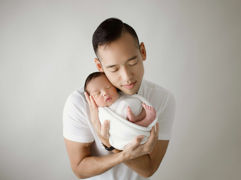 newborn-and-dad-snuggling-studio-photo-maple-grove