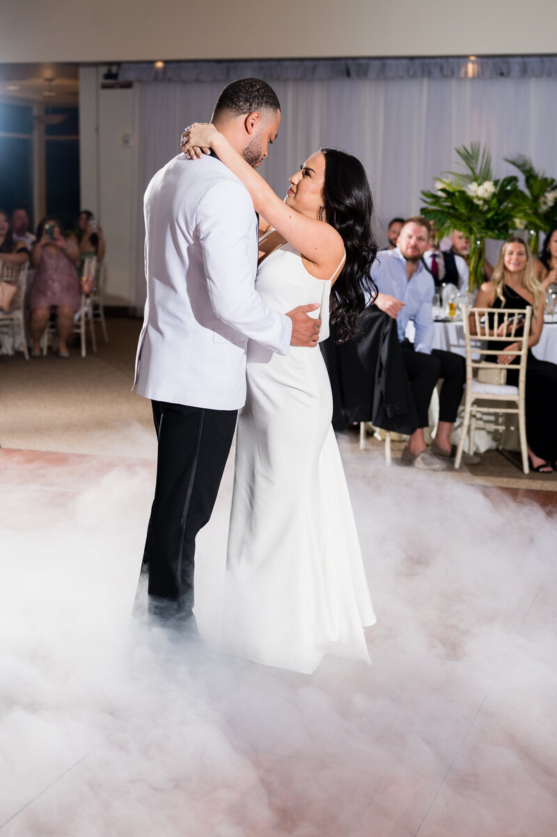 Bride and groom’s first dance under chandeliers at Emerald at Queensridge ballroom.