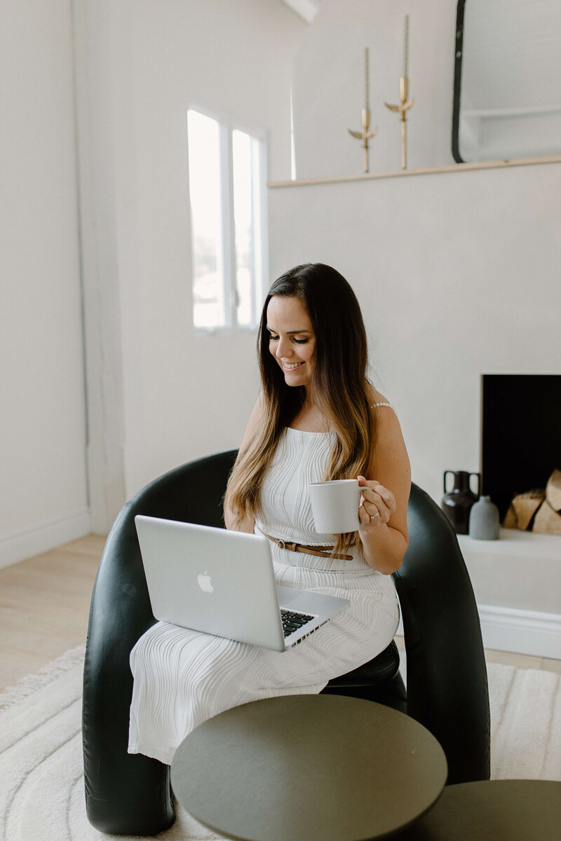 girl-working-on-laptop-with-mug-of-coffee