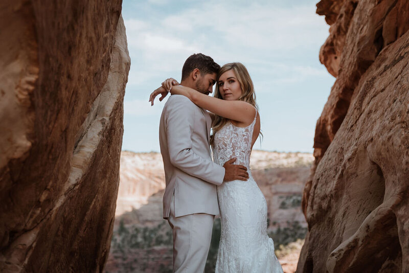 bride and groom walking in the desert