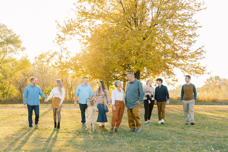 large family hanging out in a grassy field