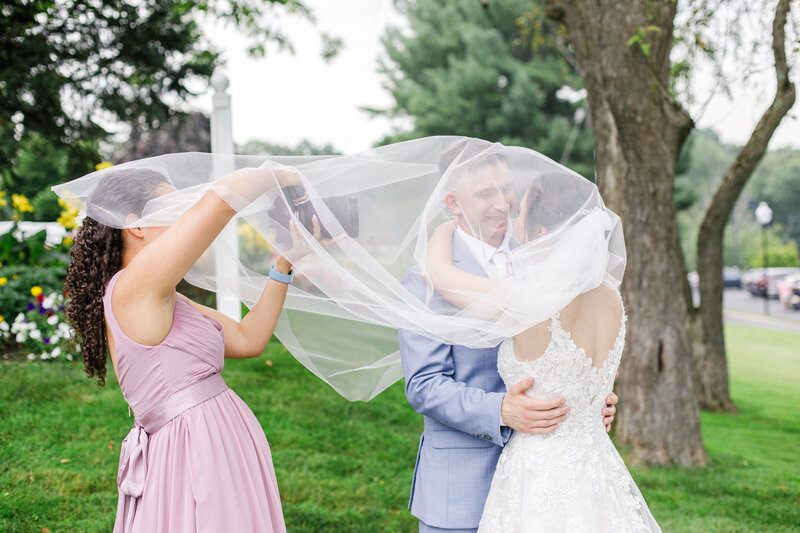 Christine Hazel Photography under a veil photographing a couple