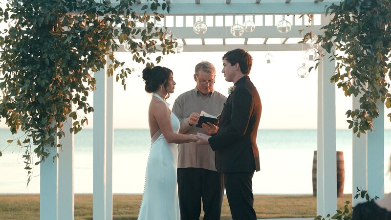 bride-and-groom-getting-married-by-beach
