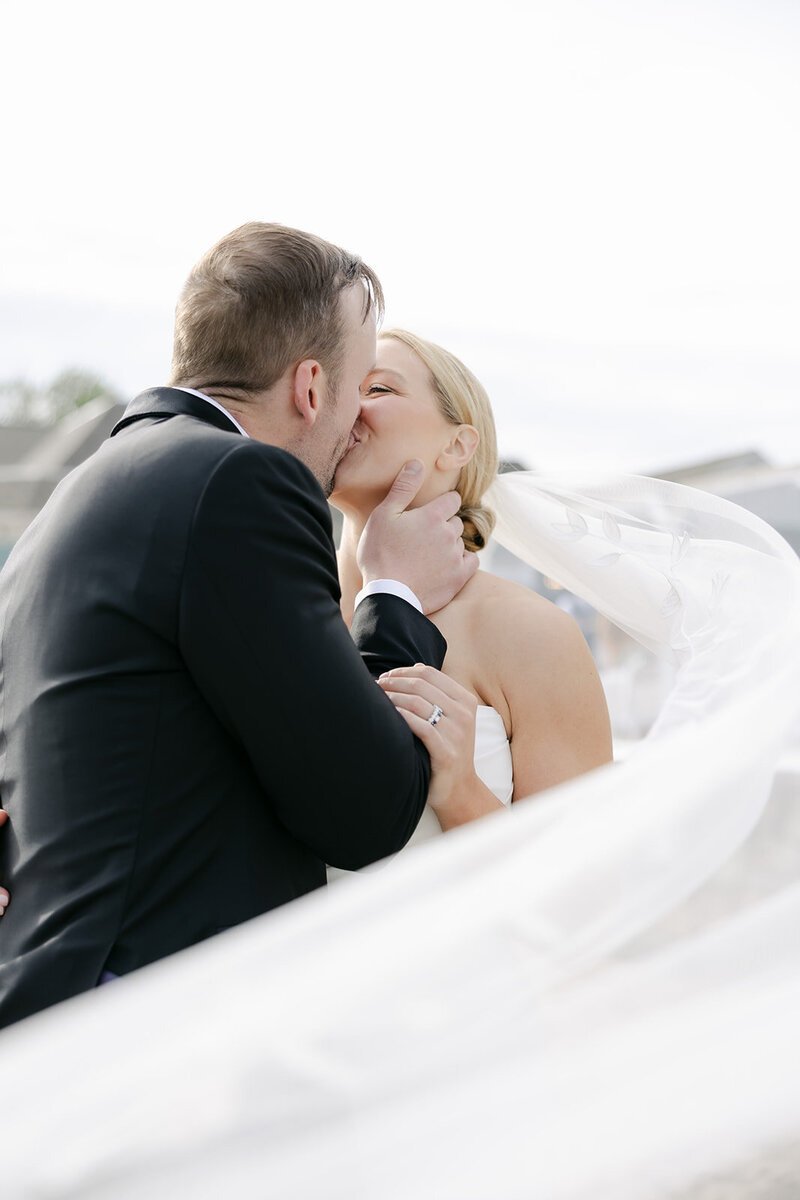 groom-bride-kiss-cathedral-veil