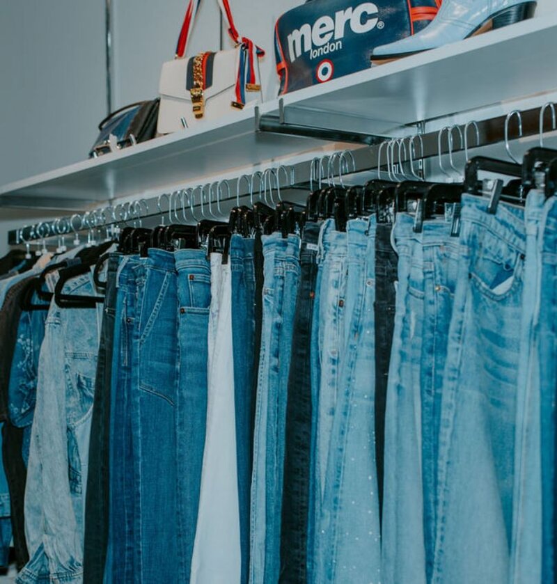 A rack of denim jeans and jackets 