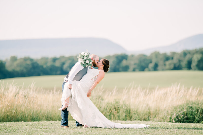 Couple embraces on a mountainside at Blue Ridge Parkway