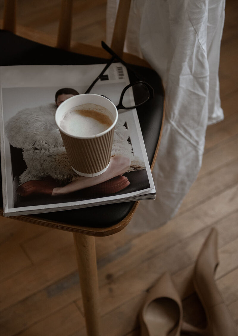 Warm photo with coffee and magazine on a chair for a business stock collection