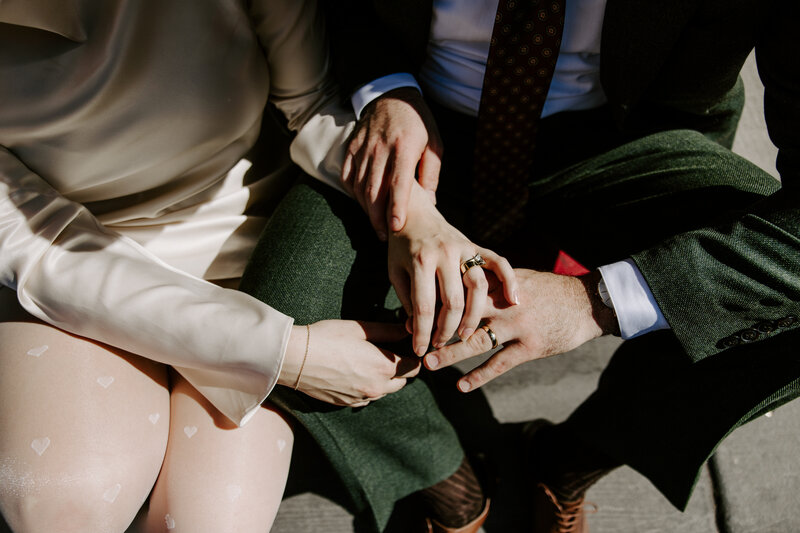 A couple holds hands.