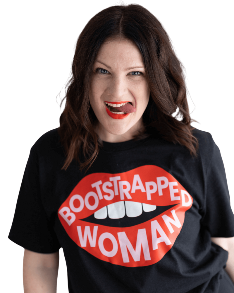 Emily, a brand and web designer, sticks her tongue out while wearing red lipstick and a black shirt with red lips that says "bootstrapped woman."