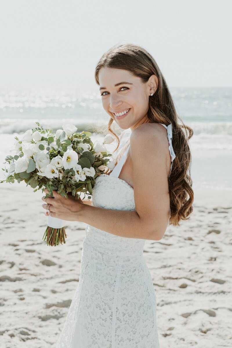 bride on beach with bouquet at Los Angeles wedding