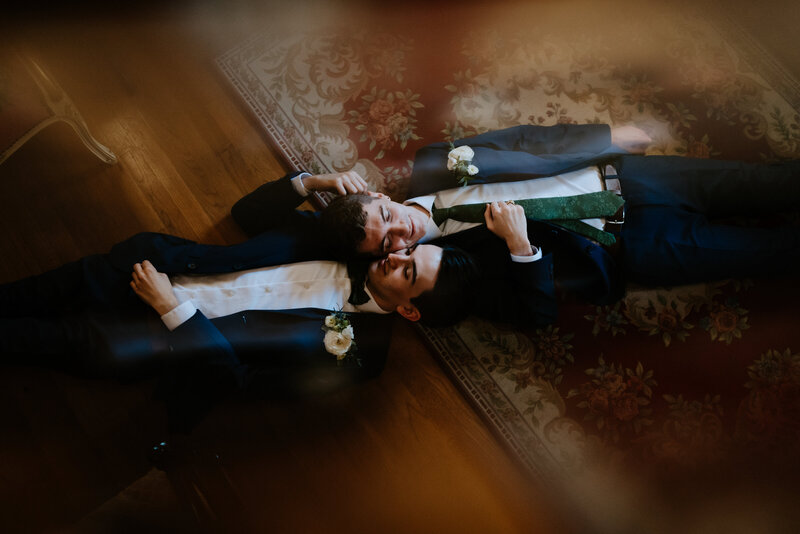 grooms lay down on ground