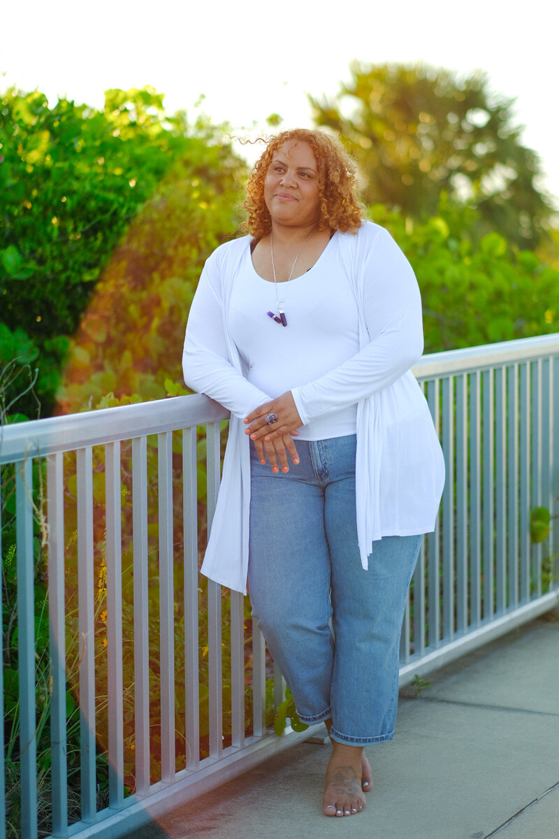 Certified life coach Claudine Martinell standing barefoot, embodying a grounded and empowering presence.