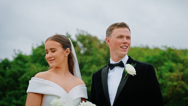 Bride and groom looking out over the sea at Saint Peter's Church Heysham  taken by wedding videographer Anthony Horseman