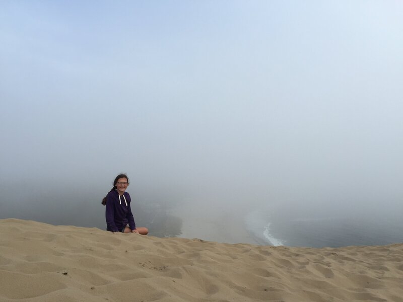 girl on top of sand dune