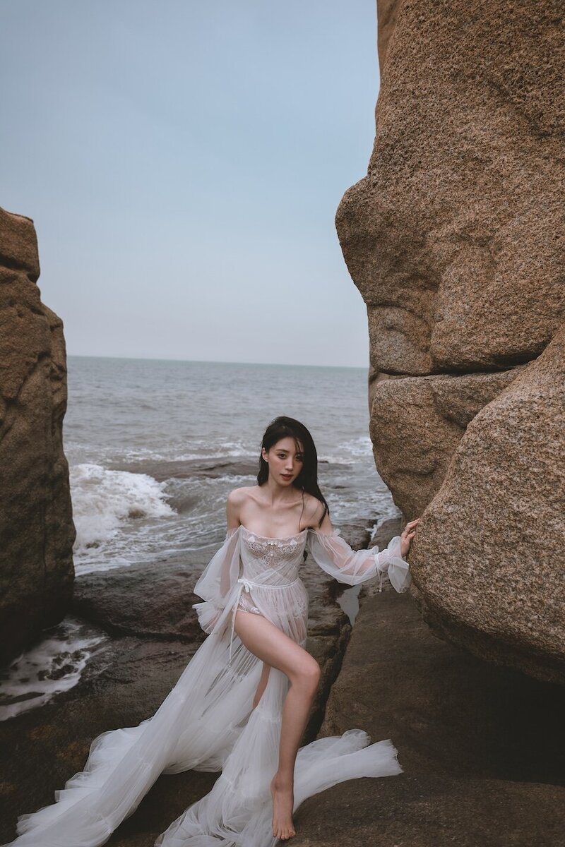 A beautiful windswept beach couture shoot amongst coastal rocks.