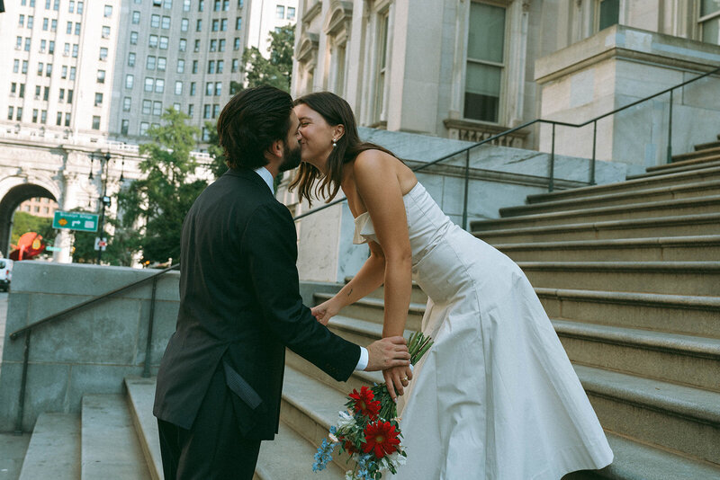 bride and groom on steps of city hall after eloping shot by Elsie Goodman Photography | NYC Elopement Packages