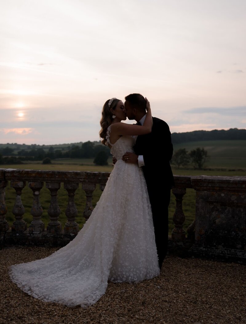 Bride kissing groom in the country side