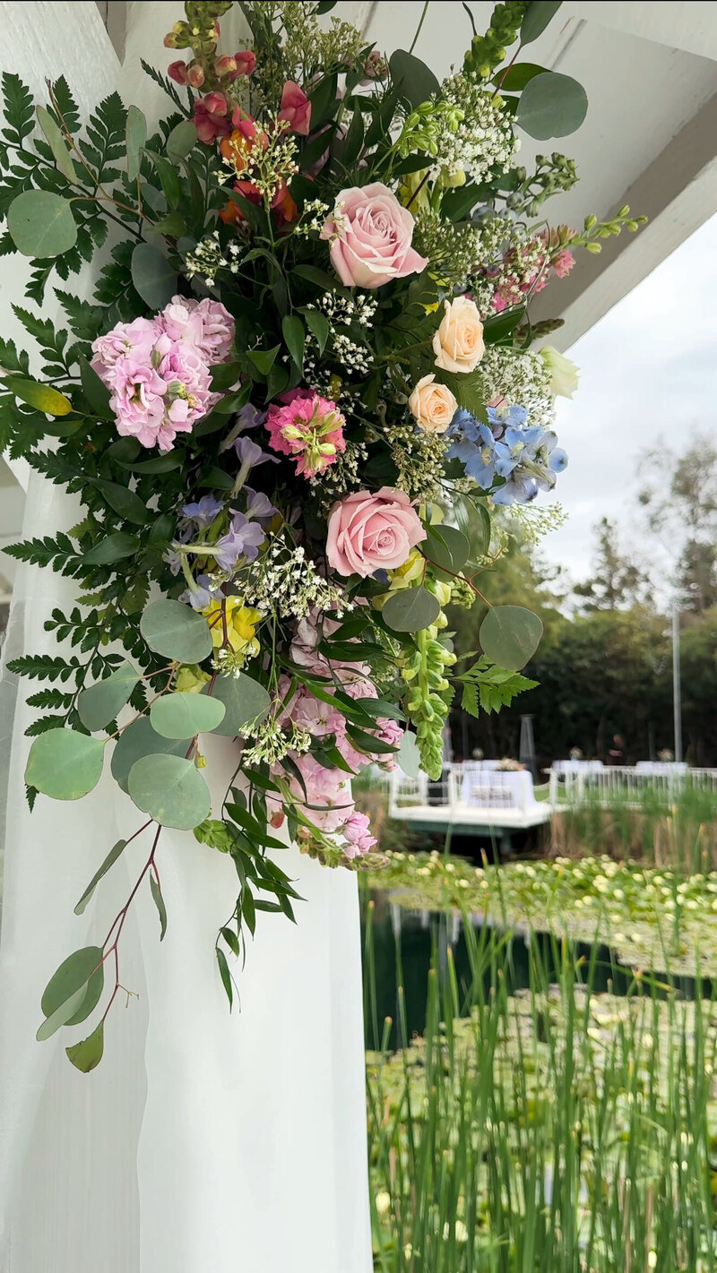Wedding ceremony flowers hanging from the gazebo at The Orchard Wedgewood Weddings in Riverside.