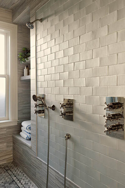 Interior design services in Boston include bathroom design for new construction and historic home remodels, featuring light grey wall tile and Samuel Heath fixtures.
