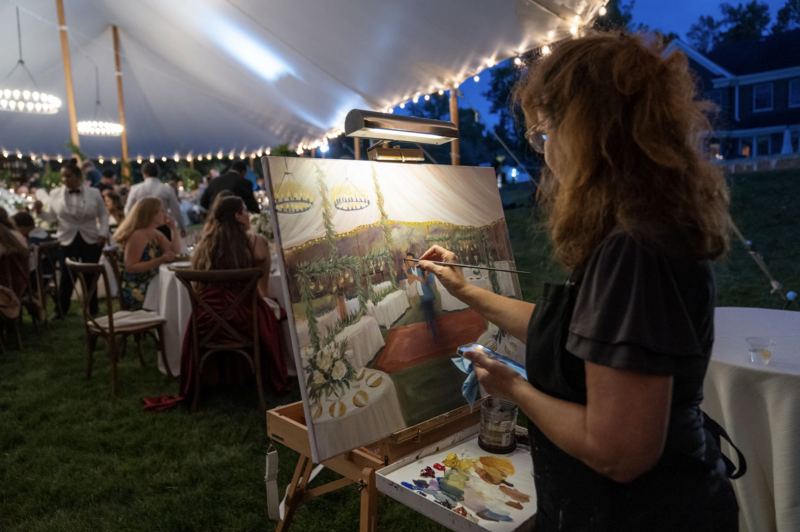 Live Painter Linda Marino painting at tent wedding in New York