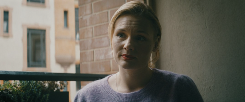 A playful conversation scene between characters, lit with soft pastels.