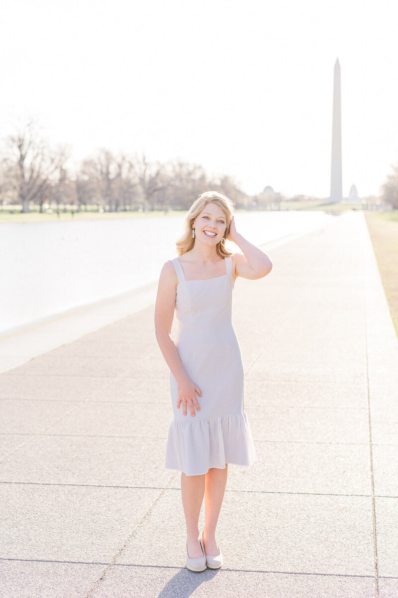 college girl posing for senior pictures by the Washington Monument