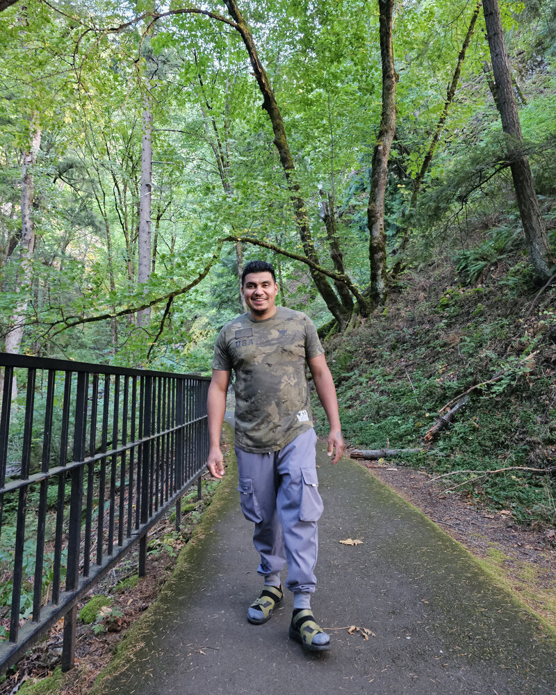 Capture the joy of biking with a friendly smile as a man enjoys a serene ride on an electric bike at Viento State Park with The Gorge E-Bike Adventure Rentals