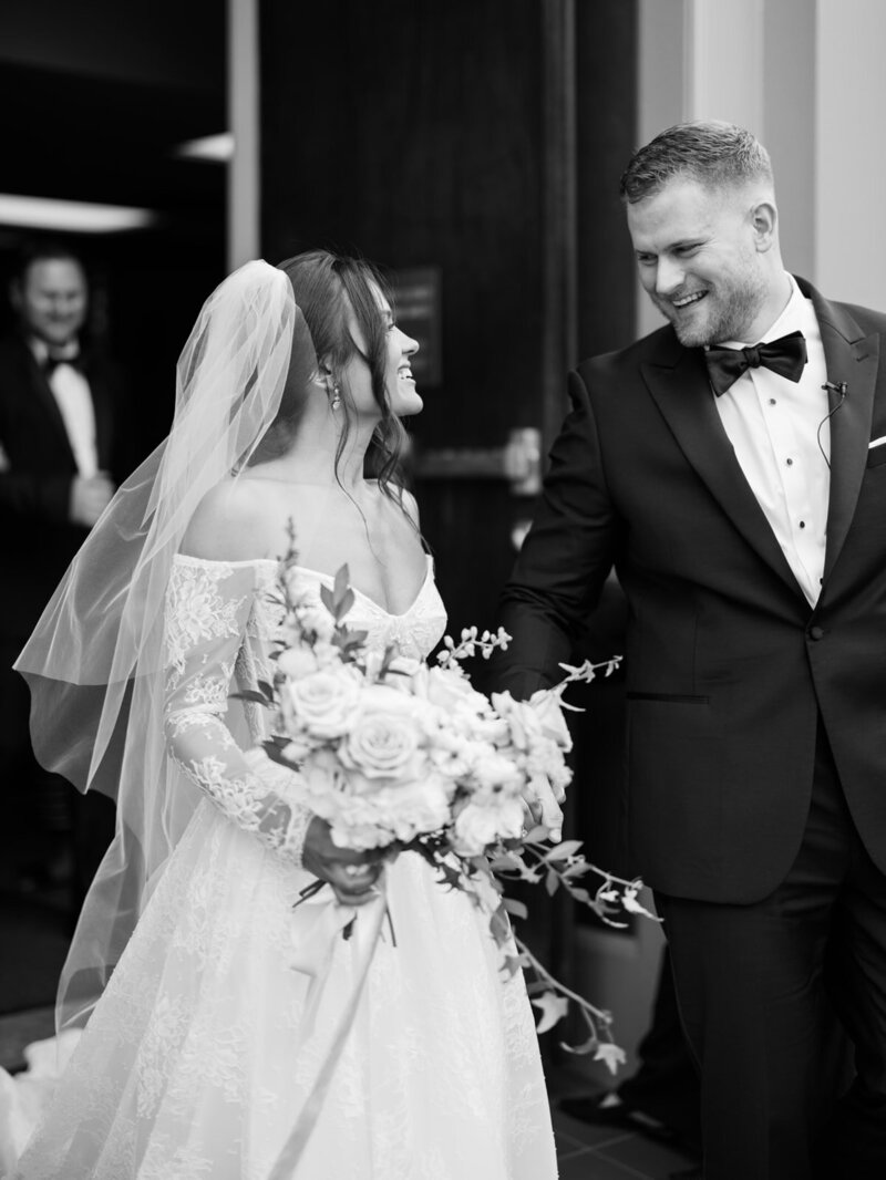 Newlywed bride and groom walking down the aisle at The Powel Crosley Estate in Sarasota, Florida—an elegant waterfront wedding celebration planned by Watters & Co. Events