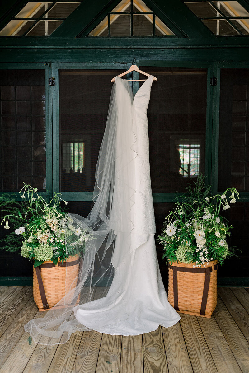 Wedding Dress hung with Adirondack baskets Loon Lake Beautiful Ballroom Wedding Hotel Saranac Photo Courtesy of Julia Rebecca Photography