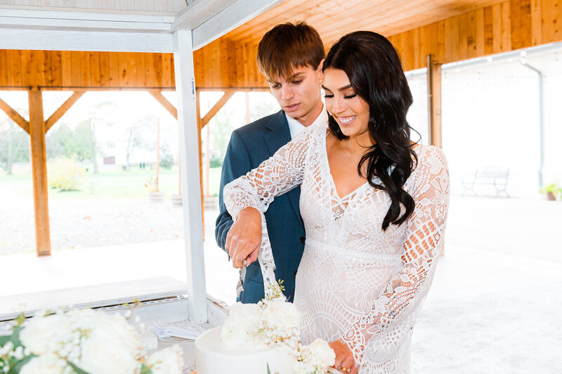 Bride and groom cutting wedding cake