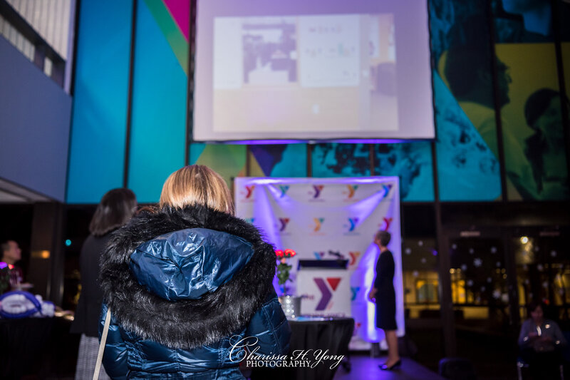 A woman watching a video on the screen at the Wayne YMCA fundraising event.