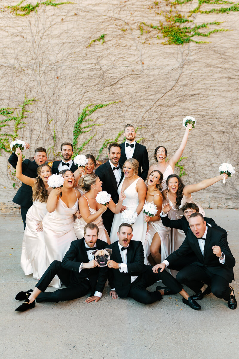 bride and groom posing with architectural building