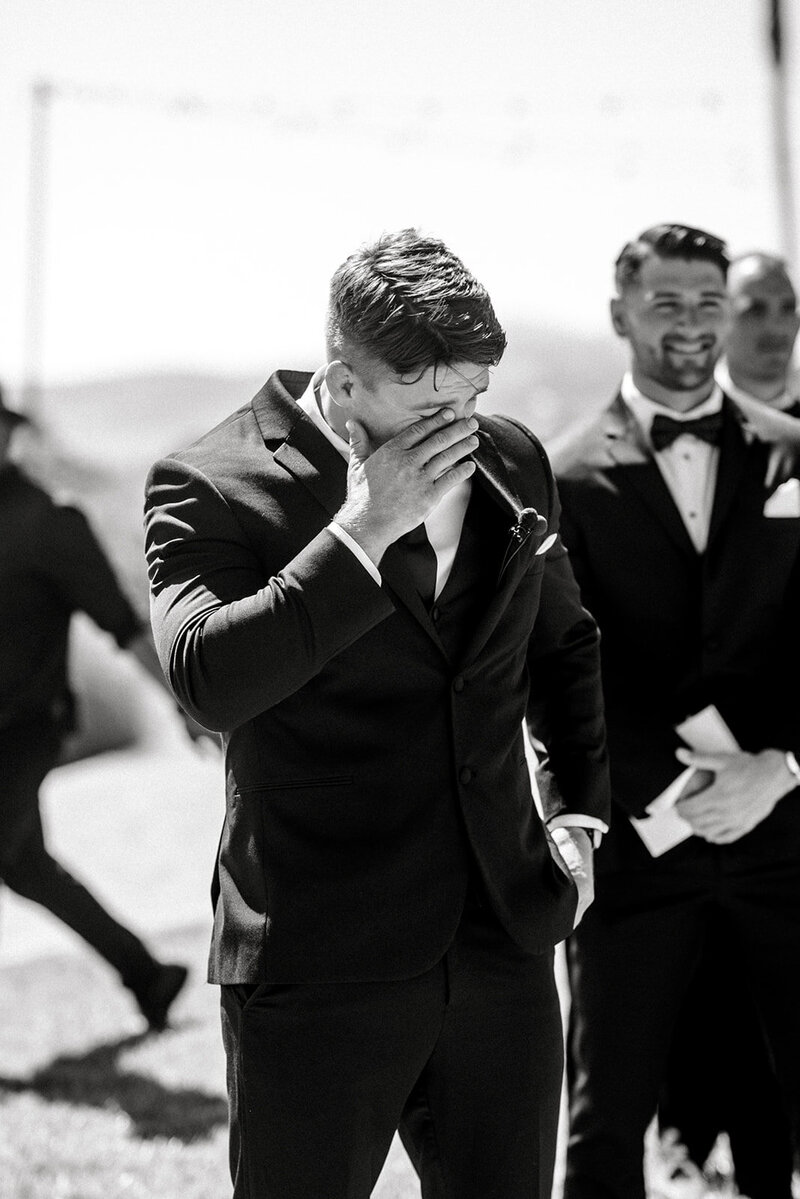 Tiffany Longeway Photography captures a deeply emotional moment as the groom awaits his bride at Carneros Resort and Spa in Napa Valley. The stunning outdoor setting, coupled with the groom’s heartfelt reaction, creates a powerful and intimate scene, ideal for couples seeking a beautiful and emotional venue for their wedding celebration.