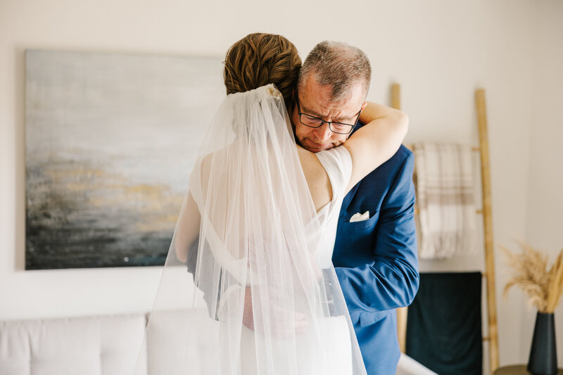 Bride's father hugging her